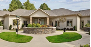 A large house with a circular driveway and a stone wall. AI generated content